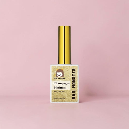 Nail Monsters Champagne Platinum gel polish bottle with a gold cap on a soft pink background.