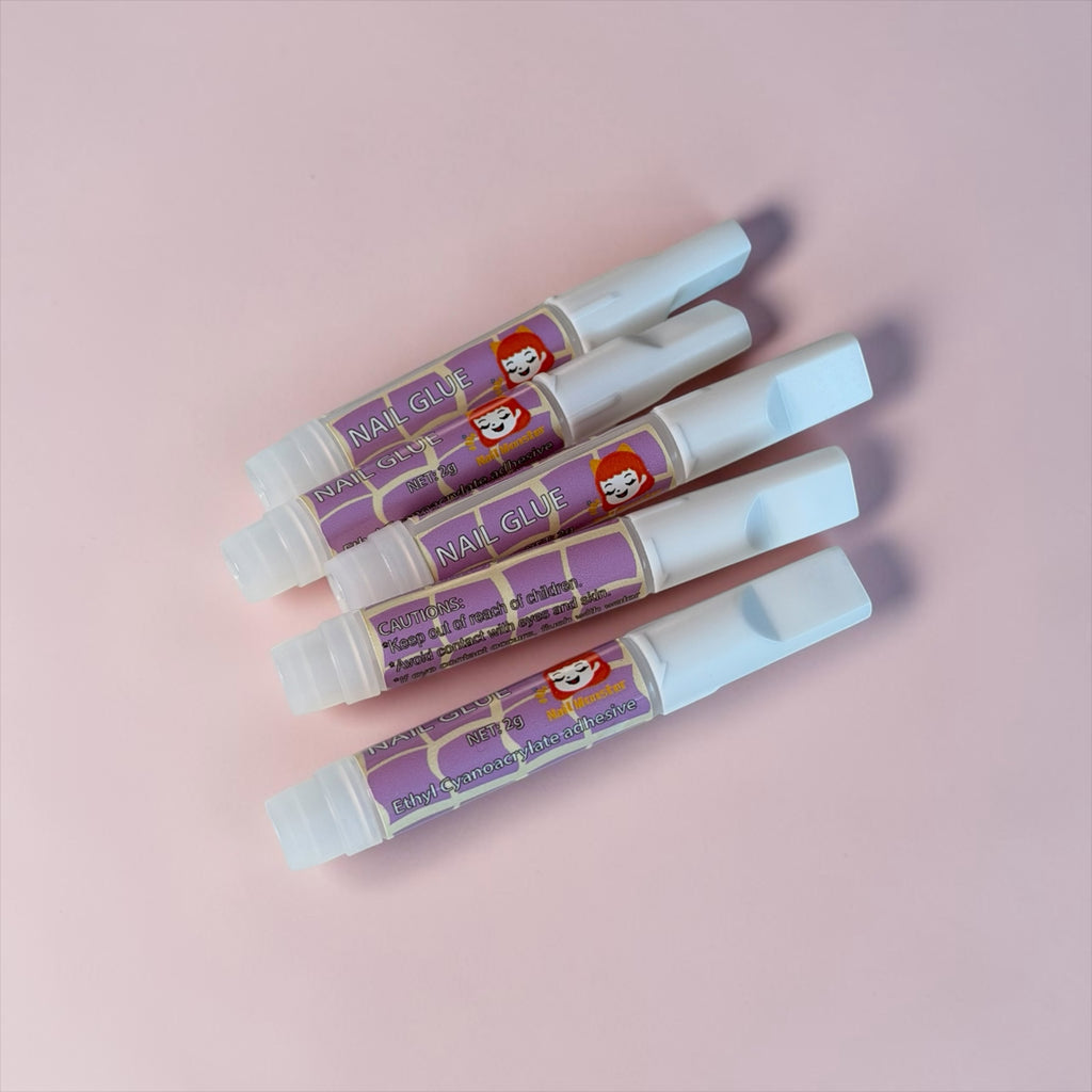 Nail Monsters professional adhesive nail glue pens with precision applicators for long-lasting press-on nail application.