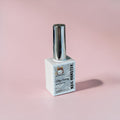 Nail Monsters Silky Creamy gel polish in a white 15ml bottle with a shiny silver cap on a soft pink background.