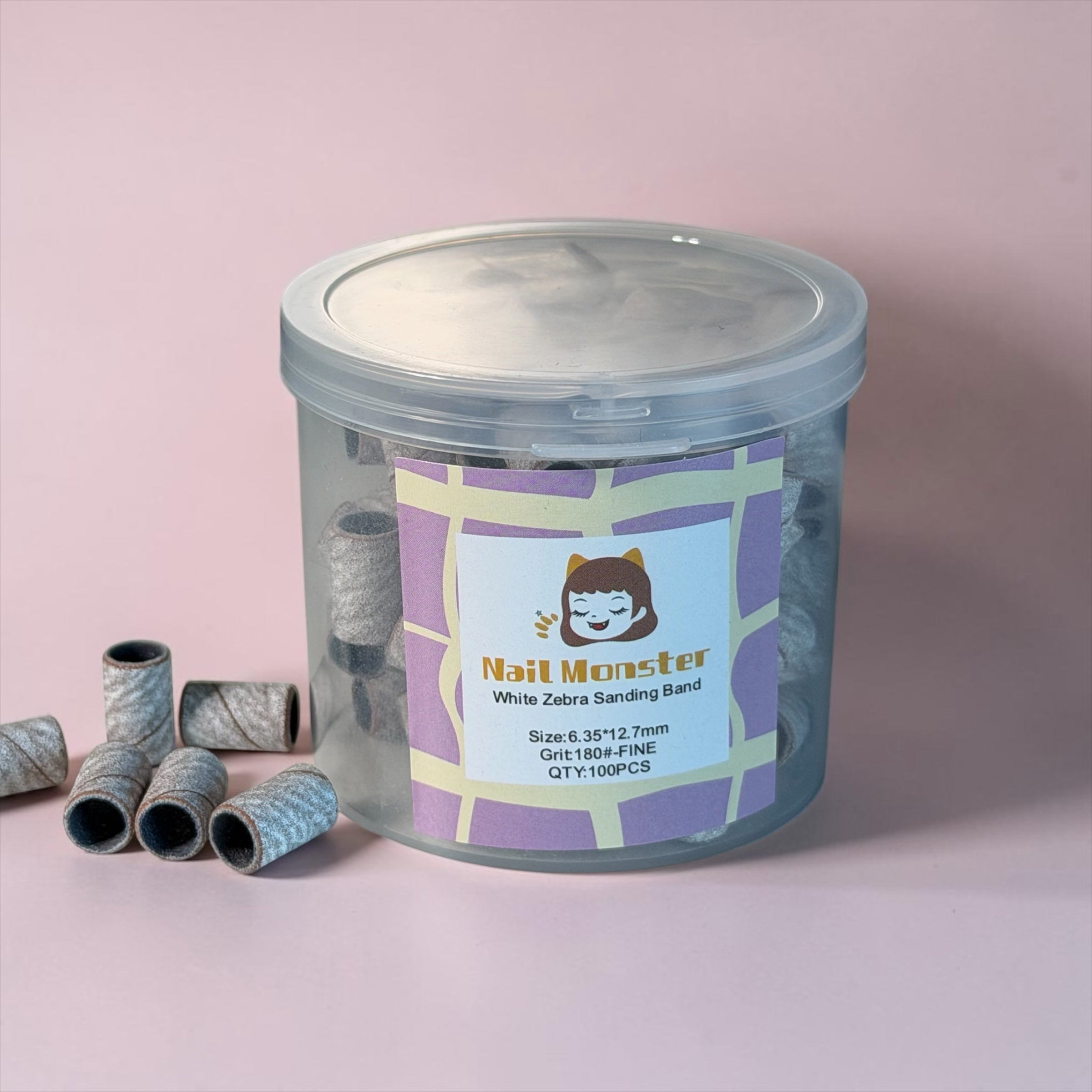 Nail Monsters 180-grit white zebra sanding bands in a clear storage jar for professional electric nail file use.